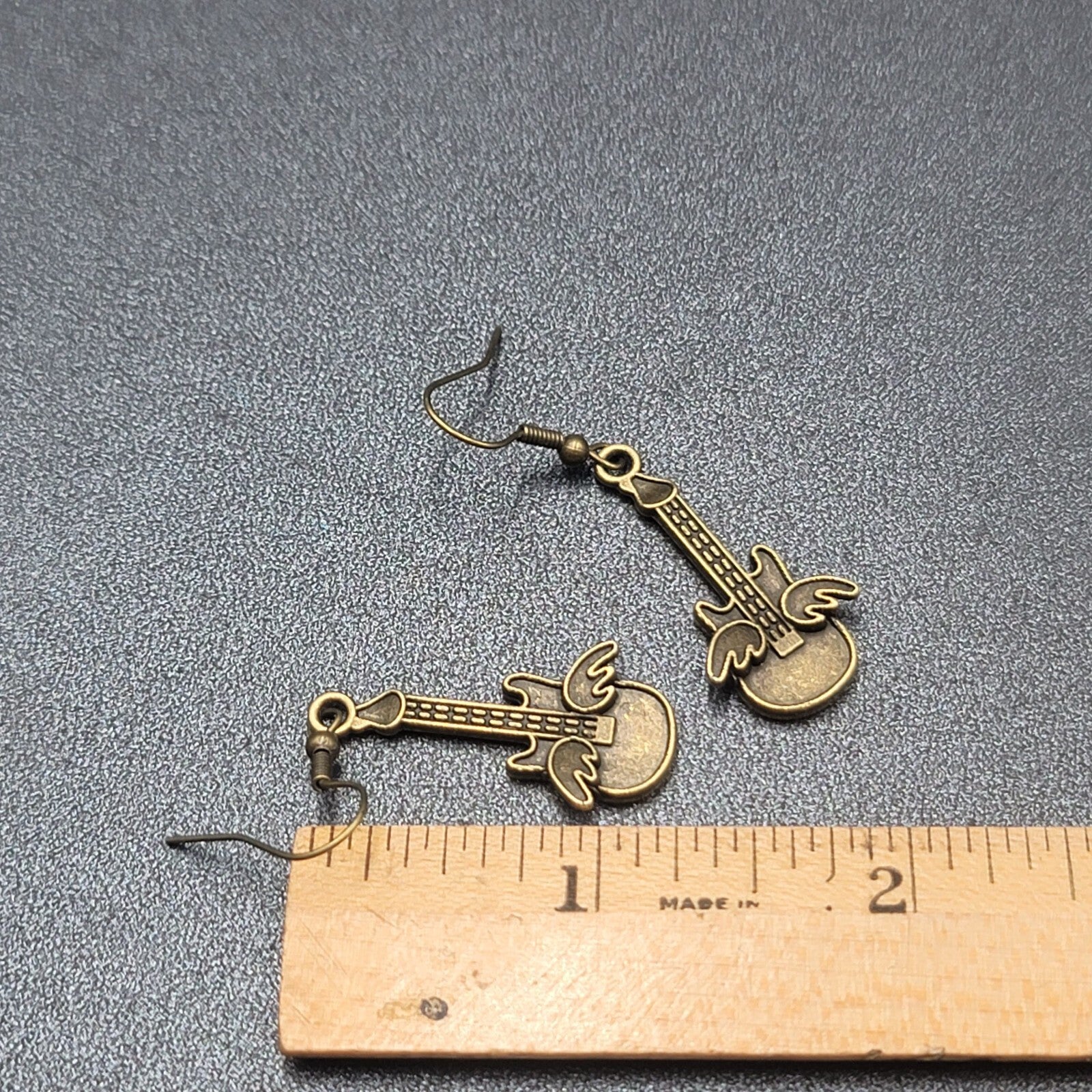 Pierced Earrings Bronze tone Embossed Winged Guitar Dangle 1.25"