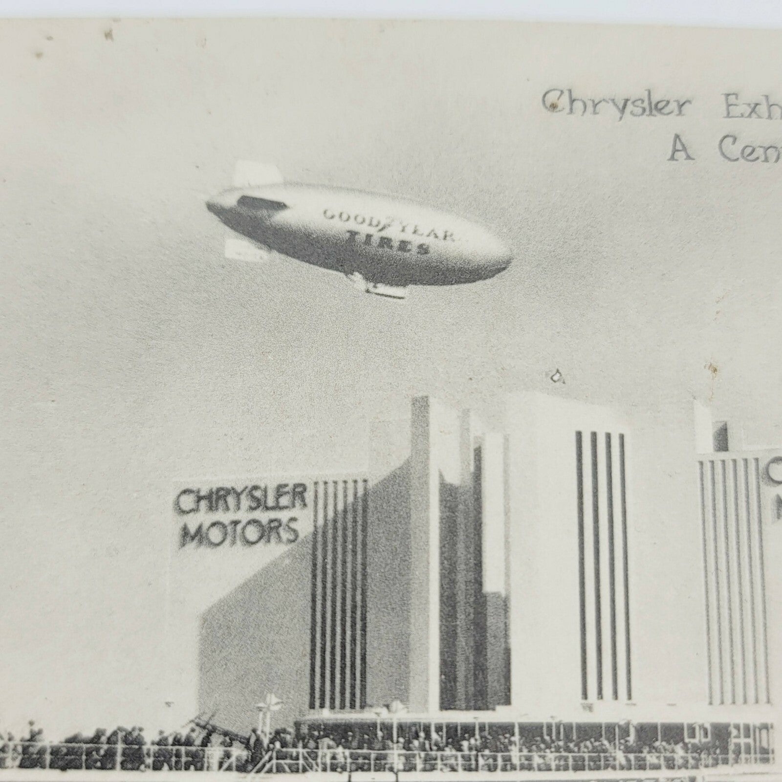 Vintage GOODYEAR BLIMP RELIANCE over Chrysler Motors Chicago ILL Postcard RPPC