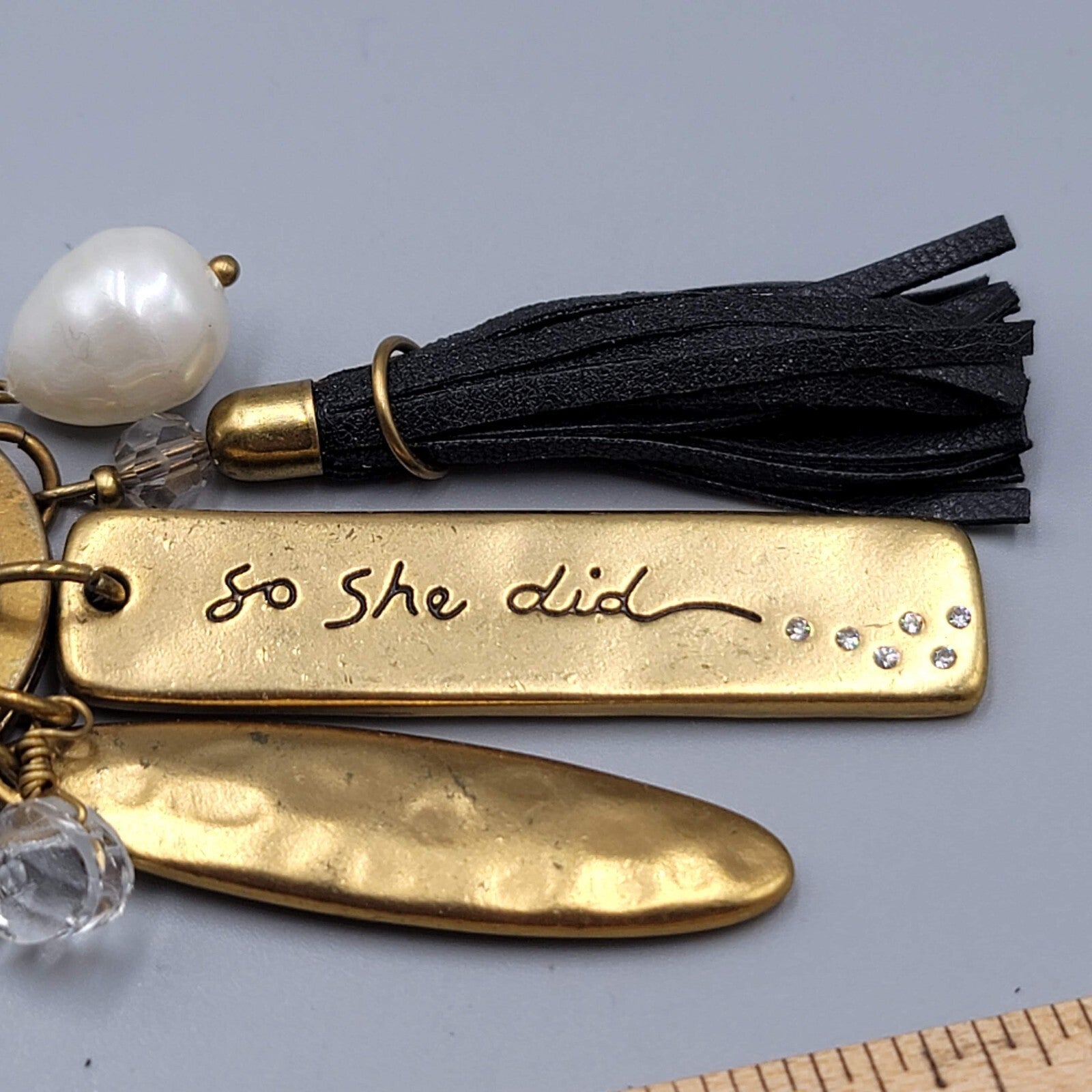 Chicos Keychain SHE BELIEVED SHE COULD Charm keychain Gold tone Black Tassel NWT
