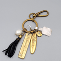 Chicos Keychain SHE BELIEVED SHE COULD Charm keychain Gold tone Black Tassel NWT