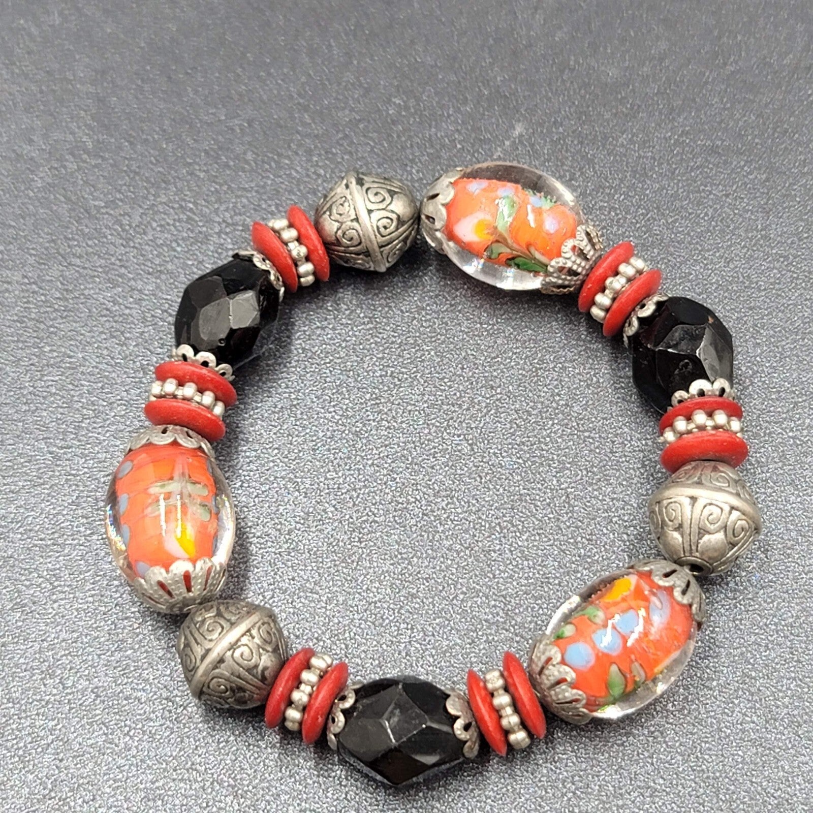 Beaded Bracelet Art Glass Red Black Silver tone Embossed Beads Elastic 6"