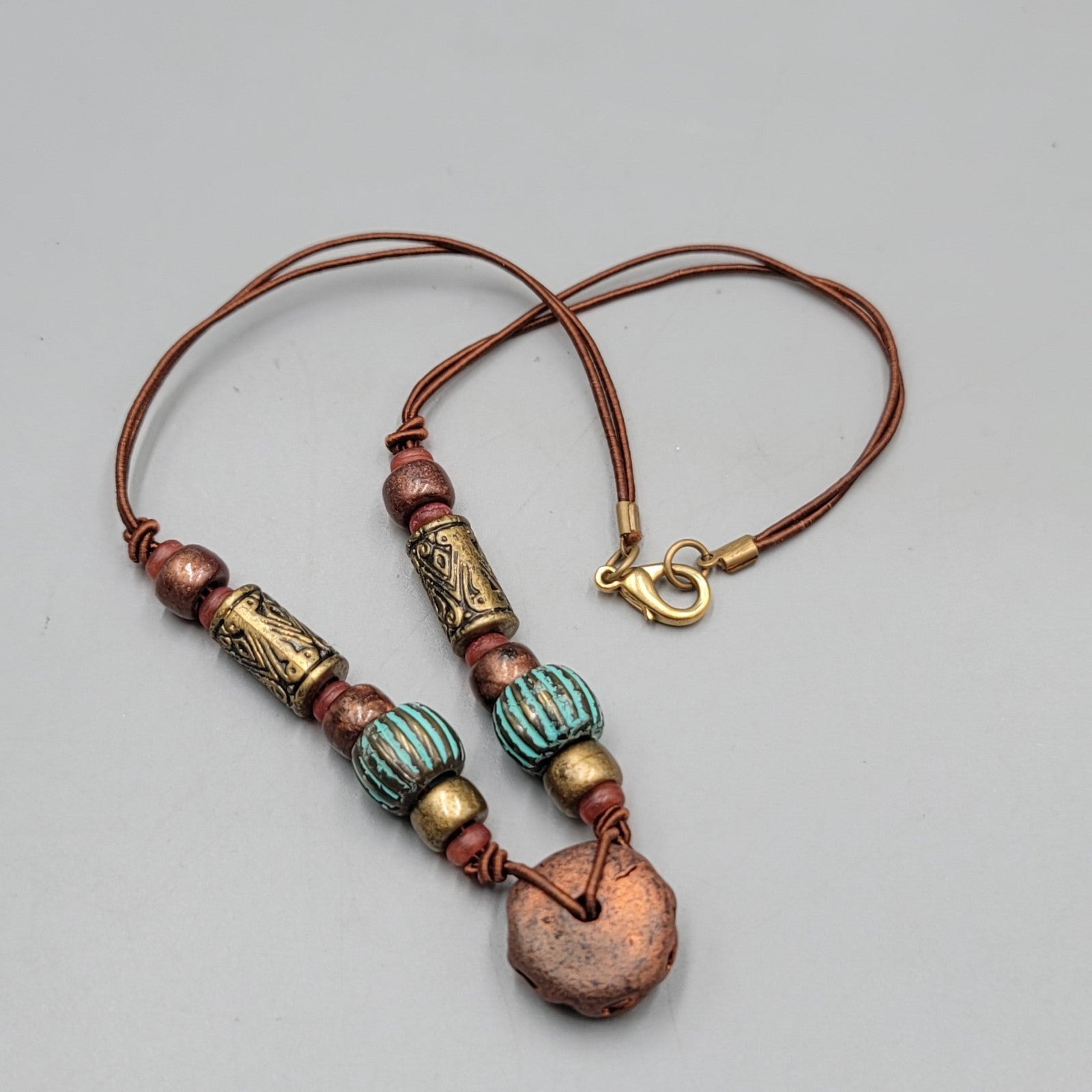 Artisan Tribal Bead Necklace Blue Bronze Colors Brown Cord 16 in