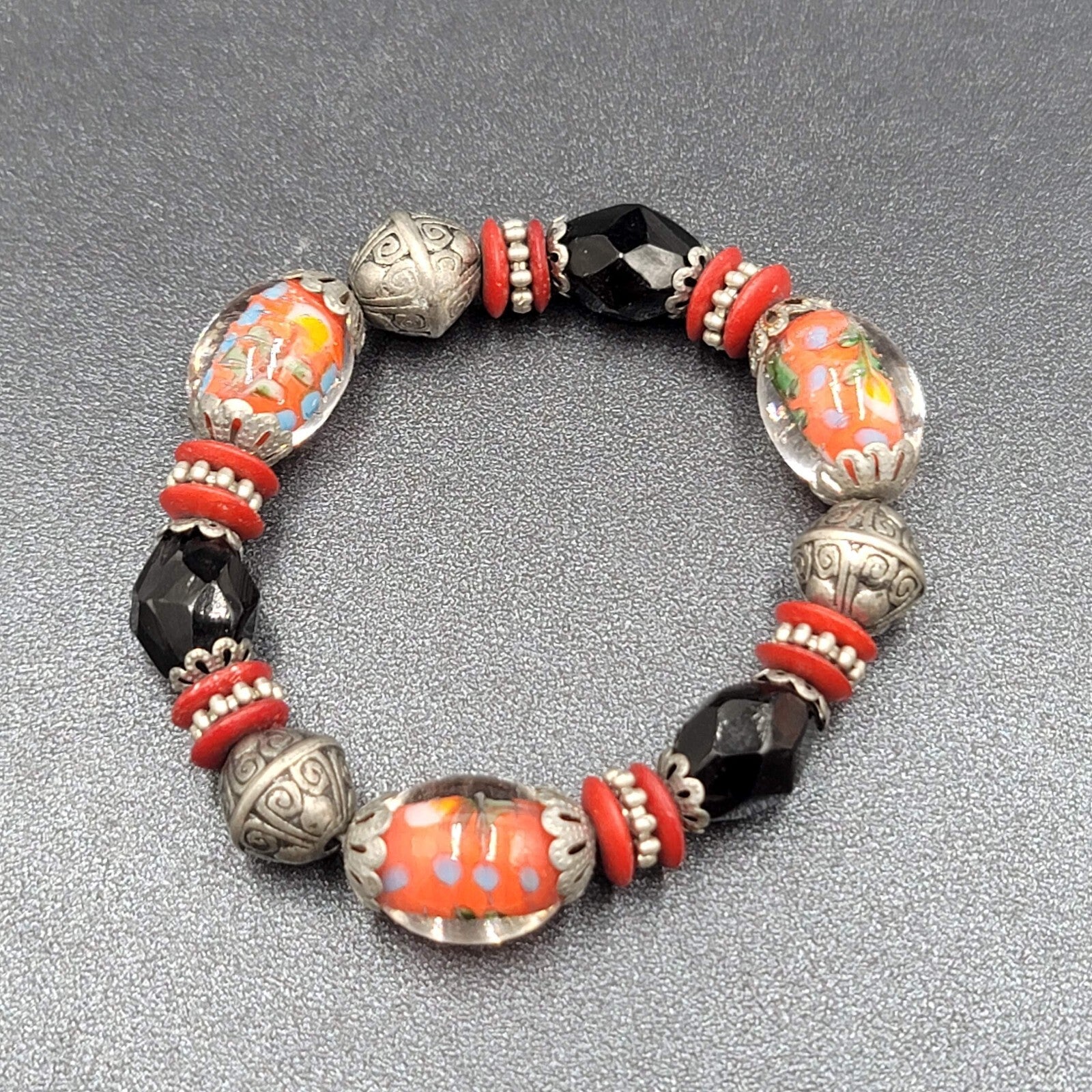 Beaded Bracelet Art Glass Red Black Silver tone Embossed Beads Elastic 6"