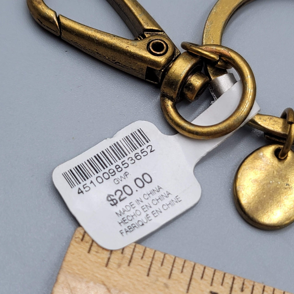 Chicos Keychain SHE BELIEVED SHE COULD Charm keychain Gold tone Black Tassel NWT