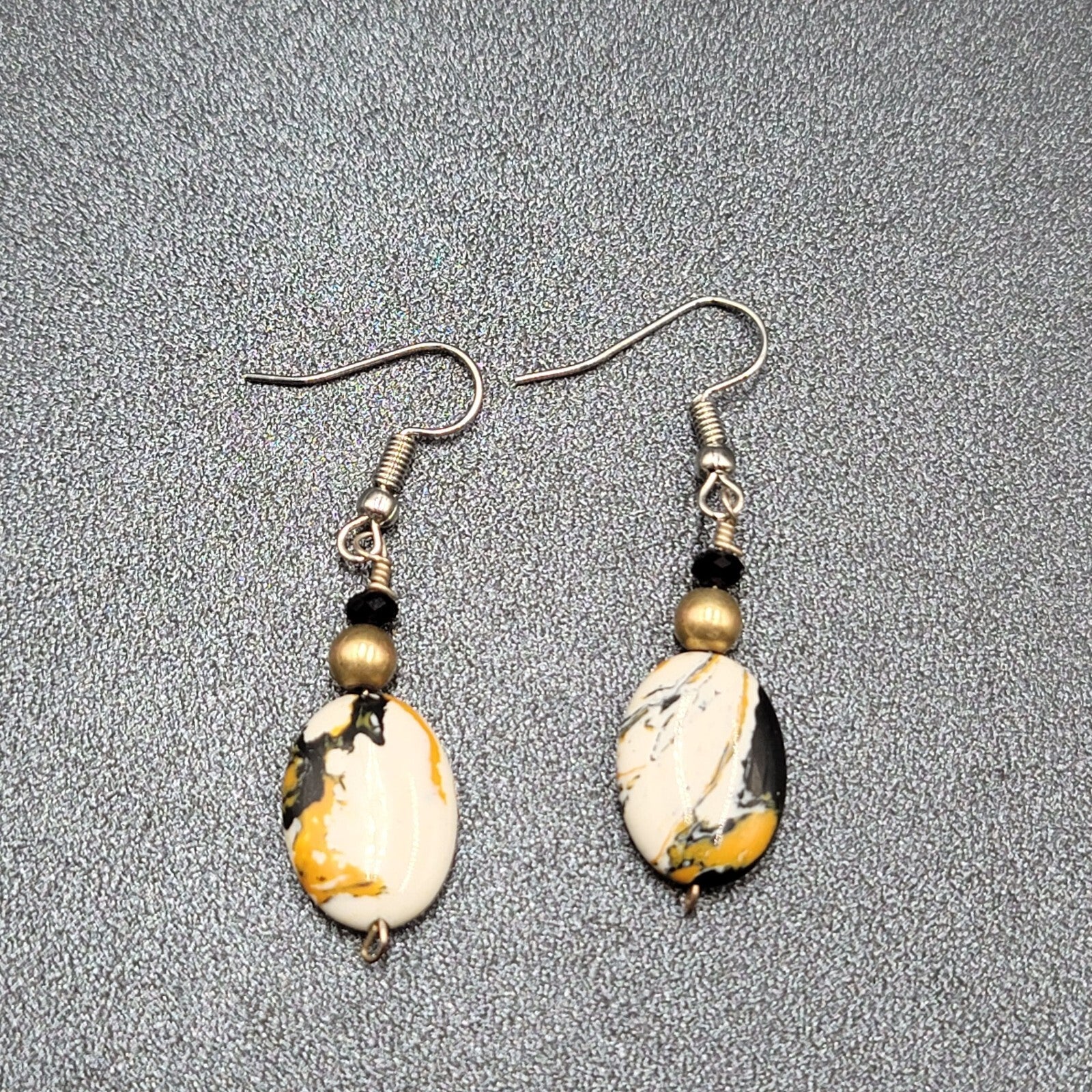 Pierced Earrings Silver tone Black White Yellow Art Glass Oval Bead Dangle 1.25"