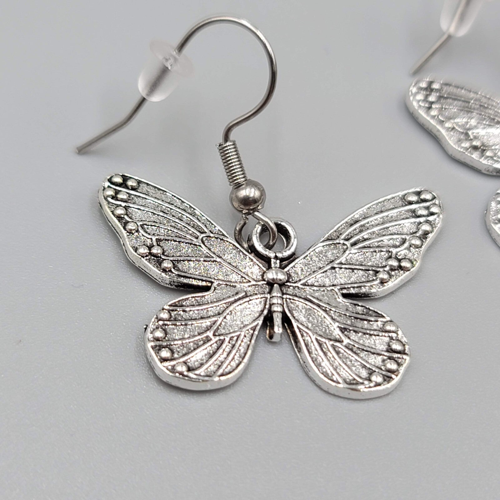 Butterfly Pierced Earrings Silver tone Embossed Dangle 3/4"