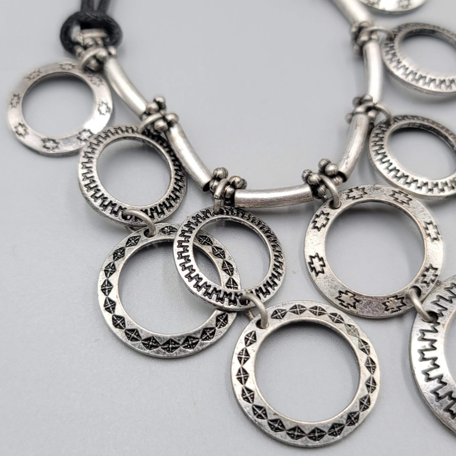 Multiple Open Rings Necklace Embossed Silver tone Black Cord 18"