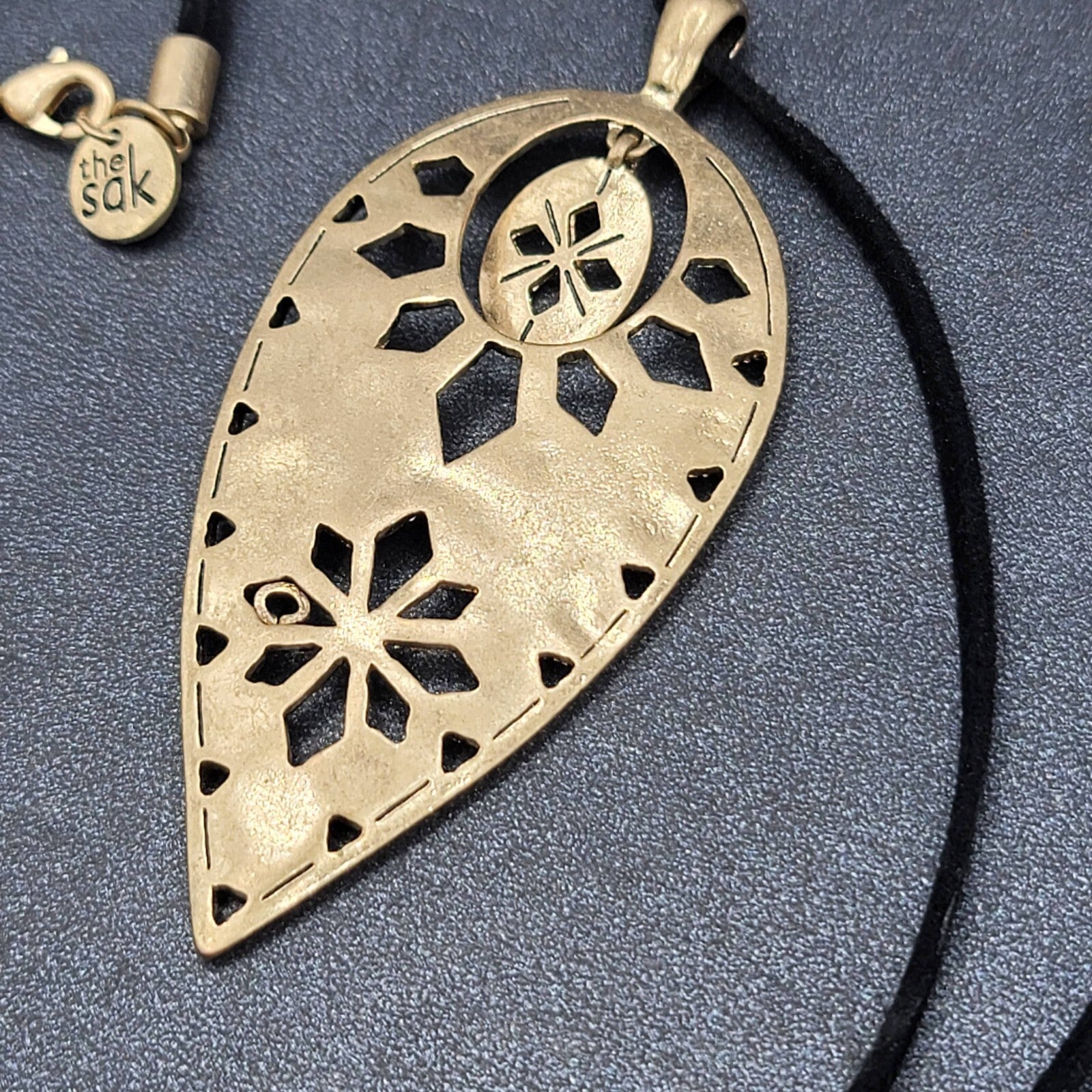 The Sak Necklace Gold tone Pendant Black Faux Leather Cord 28"