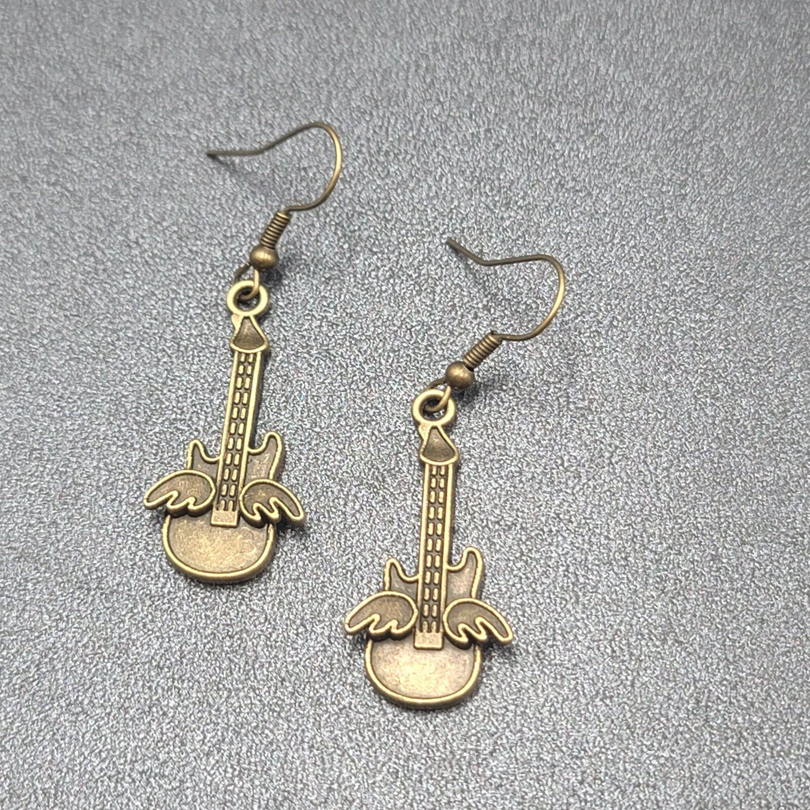 Pierced Earrings Bronze tone Embossed Winged Guitar Dangle 1.25"