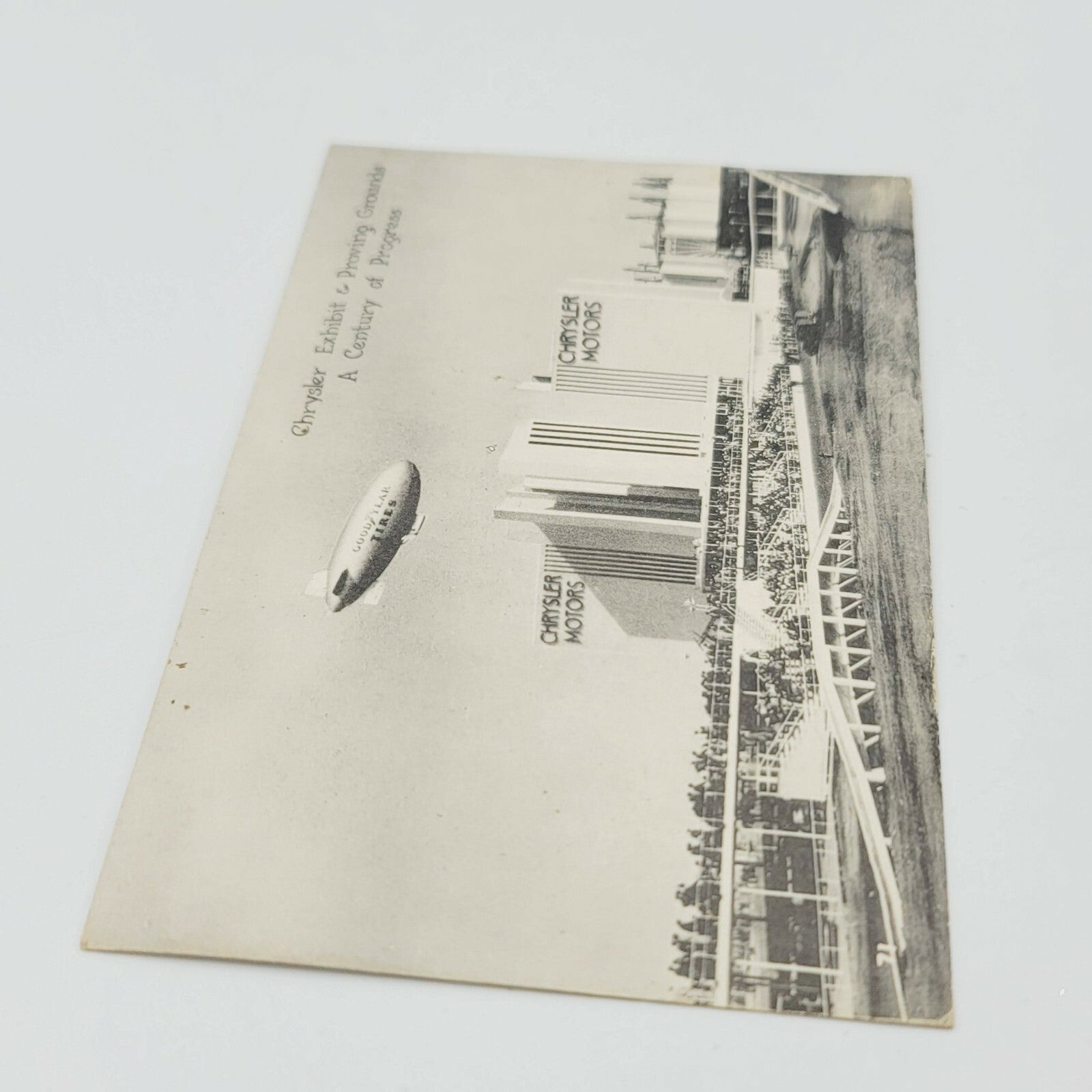 Vintage GOODYEAR BLIMP RELIANCE over Chrysler Motors Chicago ILL Postcard RPPC