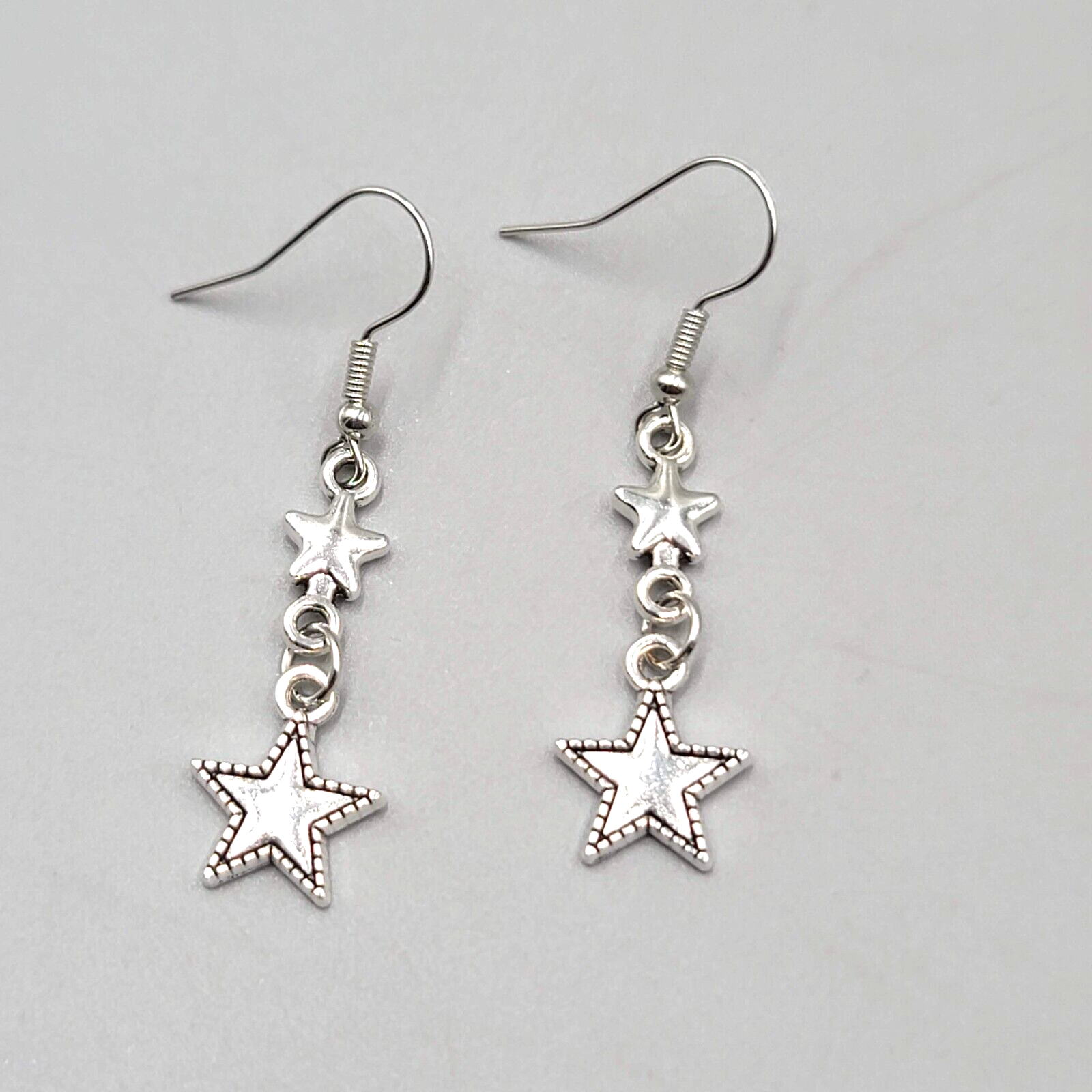 Stars Pierced Earrings Silver tone Embossed Dangle New 1 1/8"
