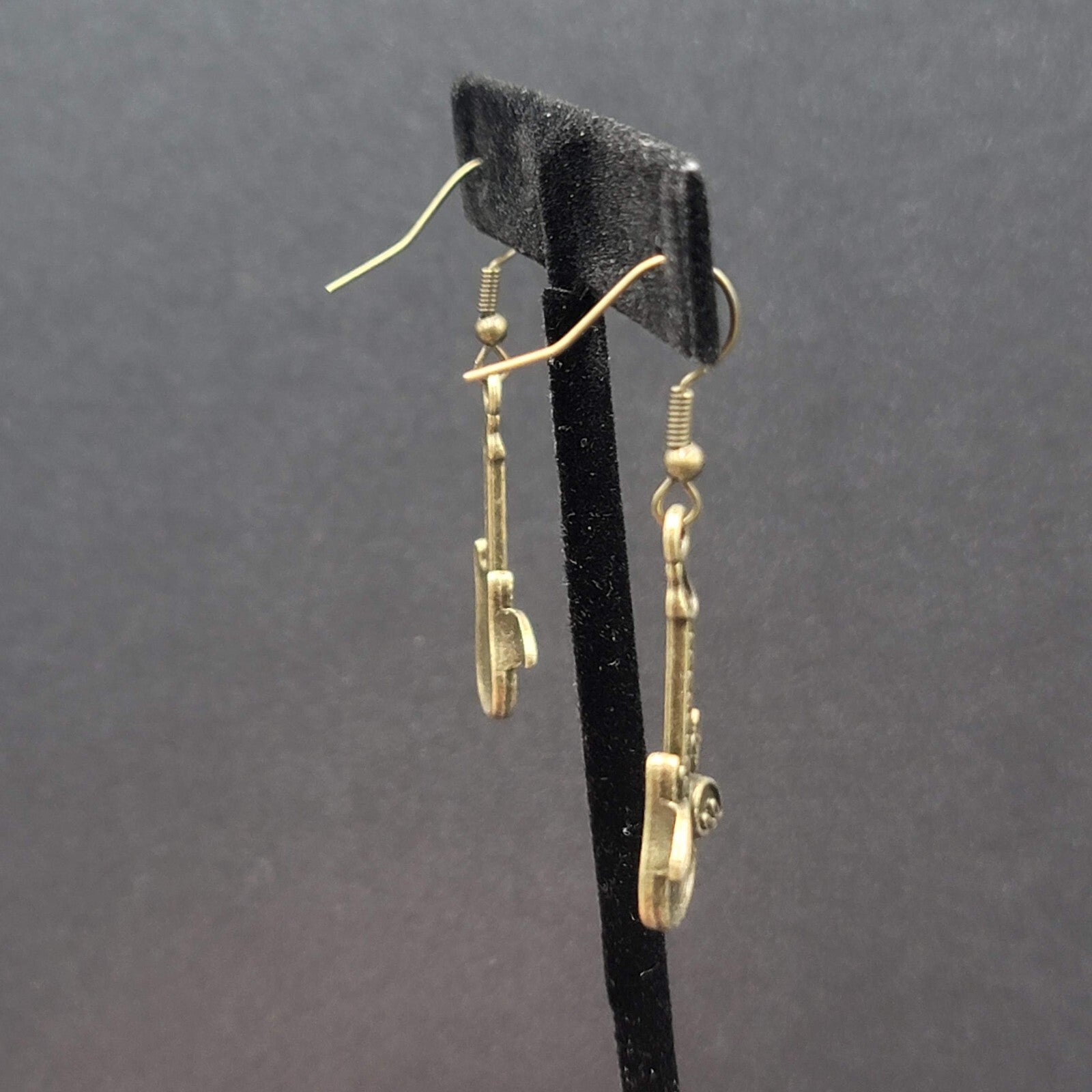 Pierced Earrings Bronze tone Embossed Winged Guitar Dangle 1.25"