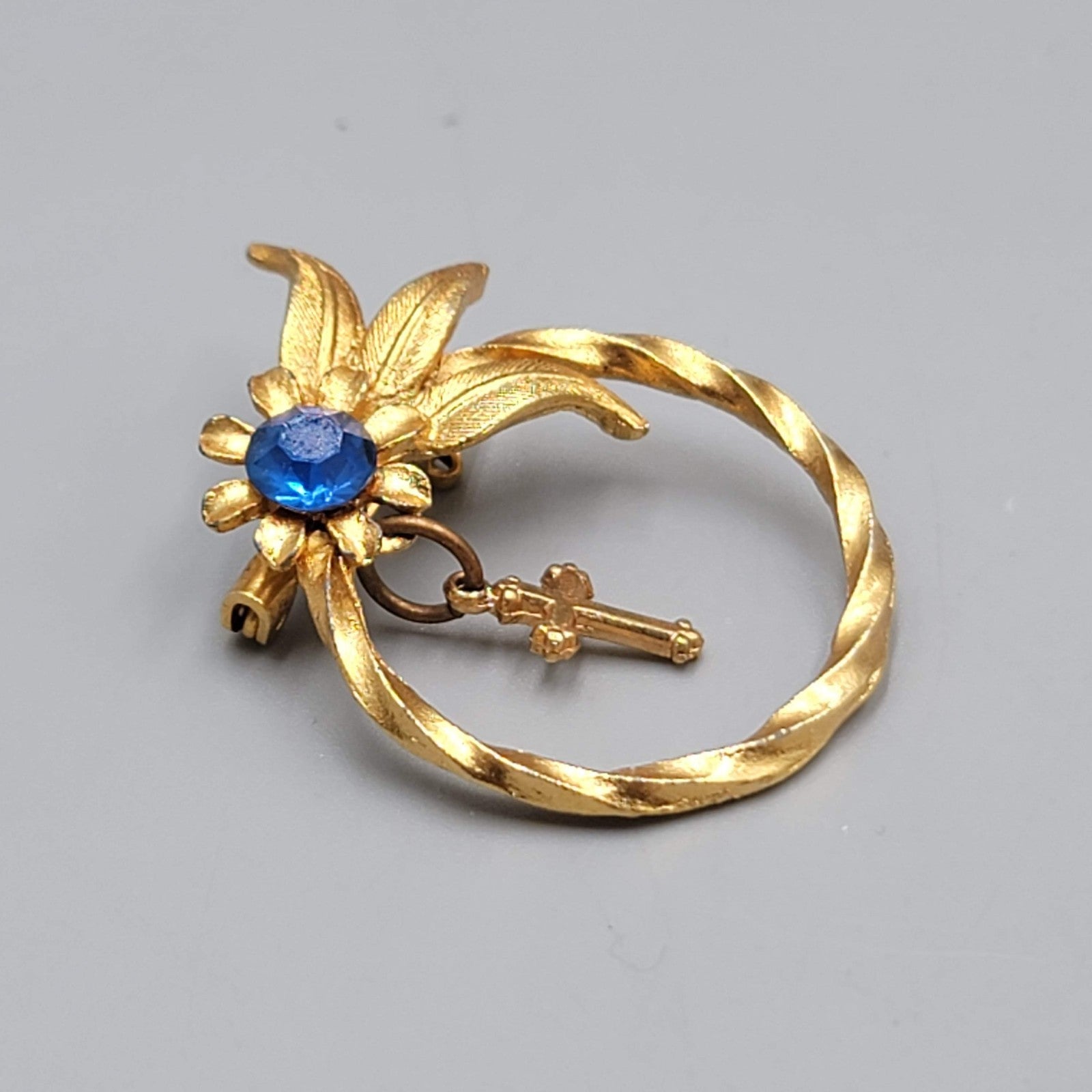 Vintage Cross Bow Blue Rhinestone Brooch Gold tone Dangle 1.25"