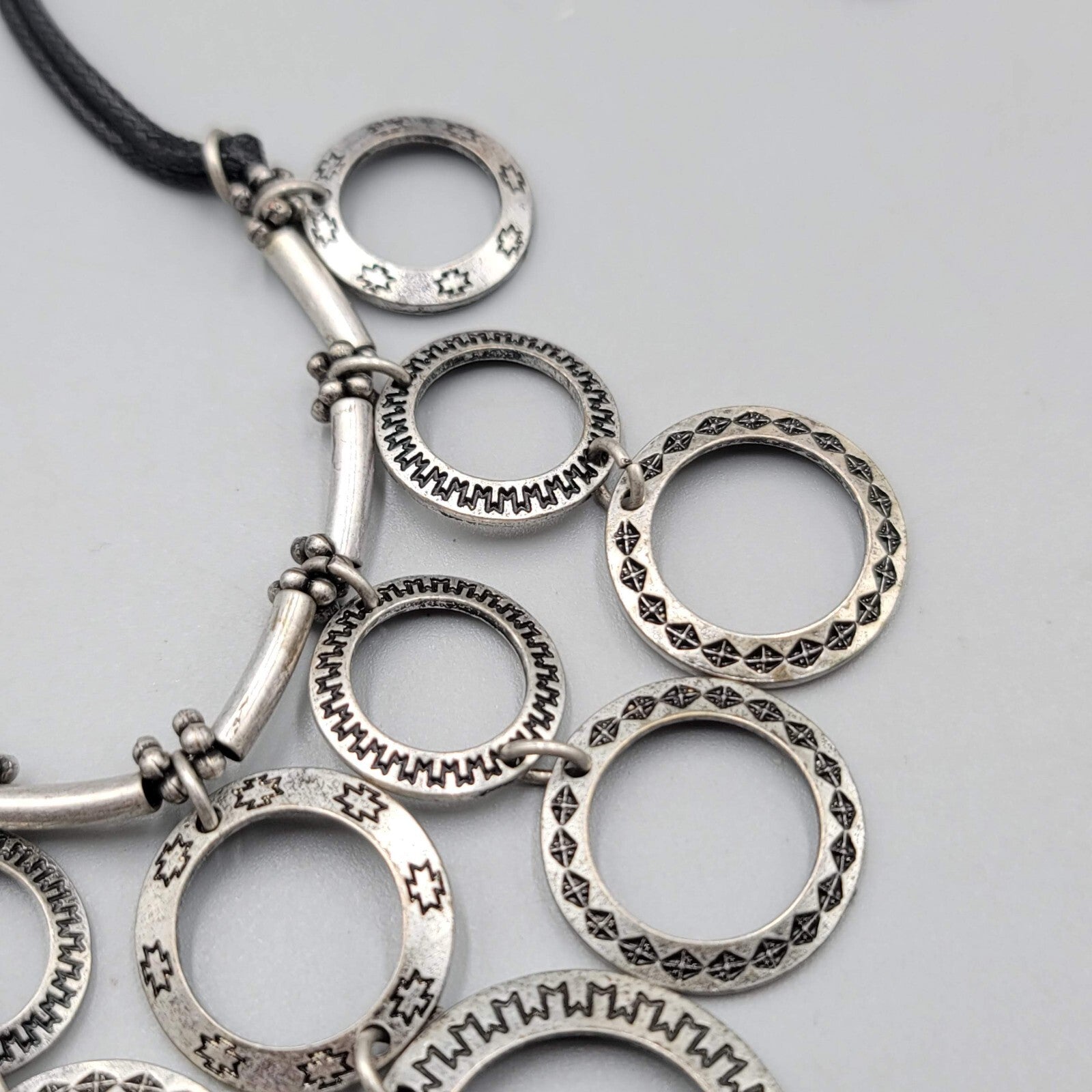 Multiple Open Rings Necklace Embossed Silver tone Black Cord 18"