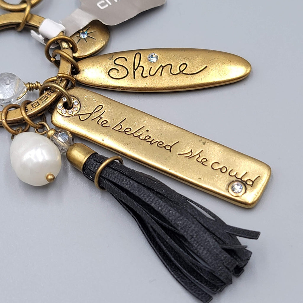 Chicos Keychain SHE BELIEVED SHE COULD Charm keychain Gold tone Black Tassel NWT