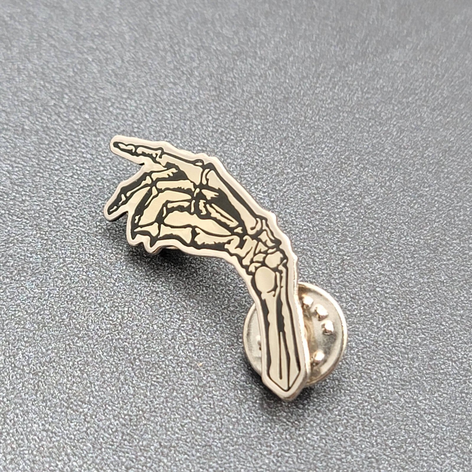 Skeleton Hand Pointing Lapel Pin Black Silver Goth Oddity 1.5"